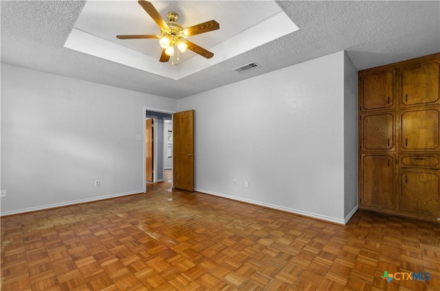 1606 Cedar Oaks Ln, Harker Heights, TX 76548 - spare room with a ceiling fan, a raised ceiling, and a textured ceiling