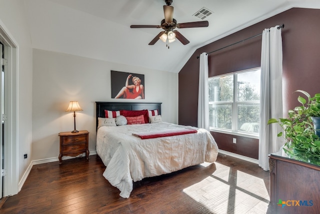 bedroom with vaulted ceiling, dark wood-type flooring, and ceiling fan