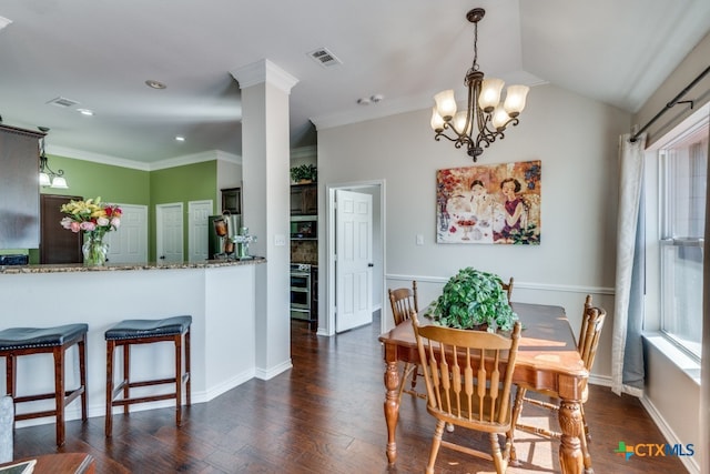 dining area with dark hardwood / wood-style flooring, ornamental molding, a wealth of natural light, and ornate columns