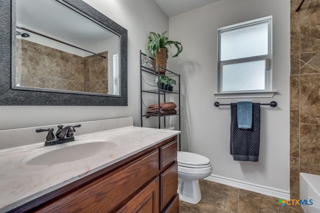 full bathroom featuring tiled shower / bath combo, vanity, and toilet