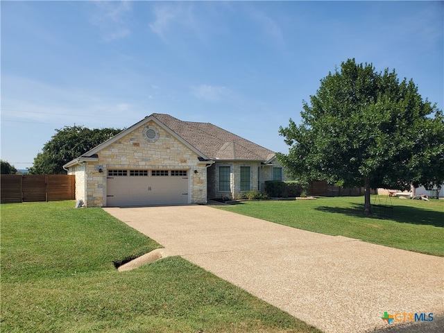 view of front of property featuring a garage and a front lawn