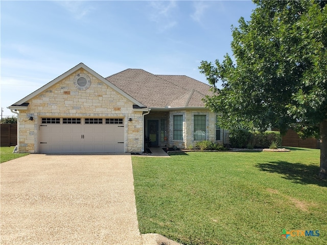 view of front of home with a garage and a front yard