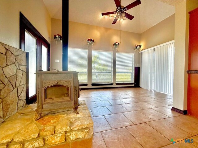 1795 Falconwood Dr, San Marcos, TX 78666 - bathroom with healthy amount of natural light, a ceiling fan, a high ceiling, and a fireplace with raised hearth