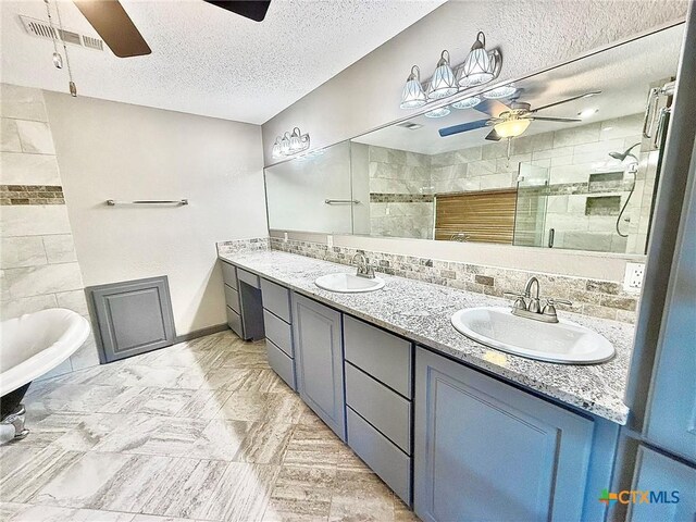 1795 Falconwood Dr, San Marcos, TX 78666 - full bathroom with a ceiling fan, a stall shower, a textured ceiling, double vanity, and decorative backsplash
