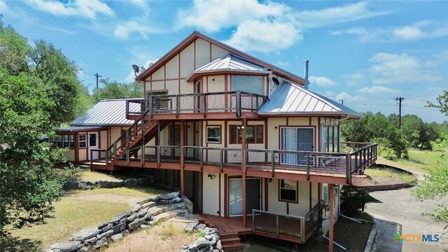 1795 Falconwood Dr, San Marcos, TX 78666 - back of house featuring stairs, a wooden deck, and stucco siding