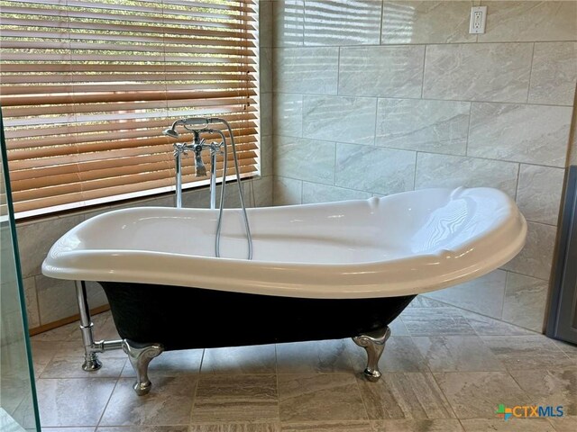 1795 Falconwood Dr, San Marcos, TX 78666 - full bath featuring a freestanding bath and tile walls