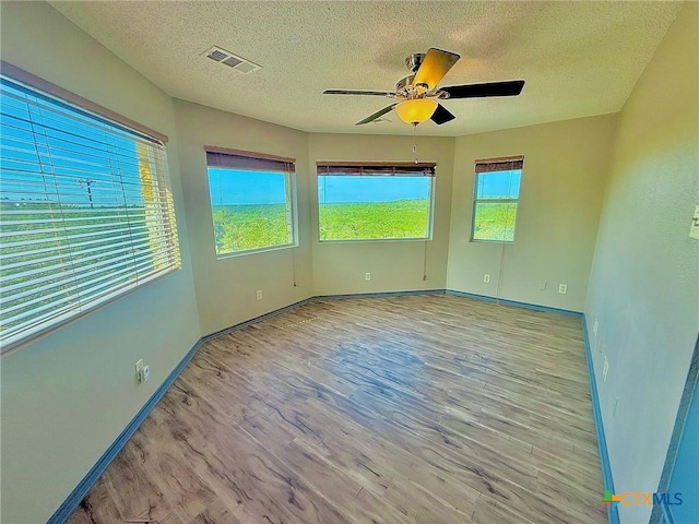 1795 Falconwood Dr, San Marcos, TX 78666 - unfurnished room with wood finished floors, ceiling fan, and a textured ceiling