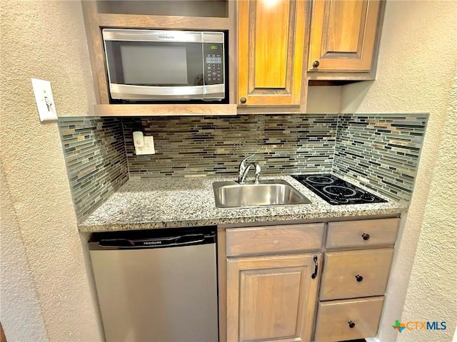 1795 Falconwood Dr, San Marcos, TX 78666 - kitchen with stainless steel appliances, decorative backsplash, a textured wall, and light stone counters