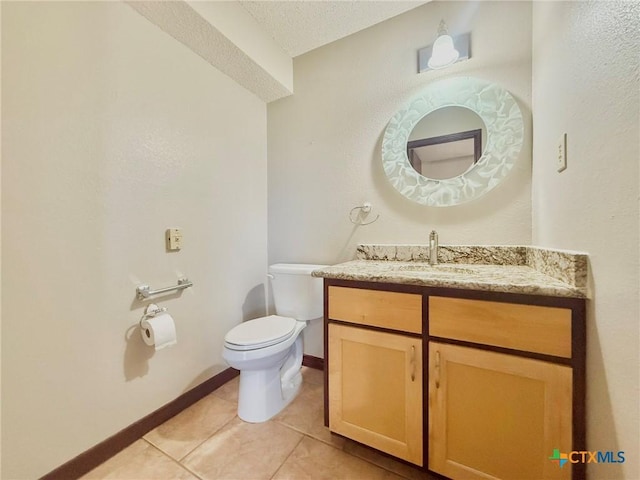 1795 Falconwood Dr, San Marcos, TX 78666 - half bathroom featuring vanity, tile patterned floors, and a textured ceiling