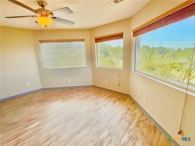 1795 Falconwood Dr, San Marcos, TX 78666 - empty room featuring wood finished floors, ceiling fan, and a textured ceiling