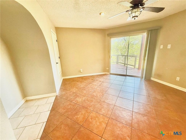 1795 Falconwood Dr, San Marcos, TX 78666 - spare room with light tile patterned flooring, a textured ceiling, arched walkways, and ceiling fan