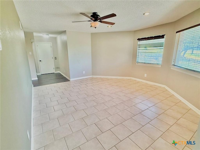 1795 Falconwood Dr, San Marcos, TX 78666 - empty room with ceiling fan, a textured ceiling, and tile patterned flooring