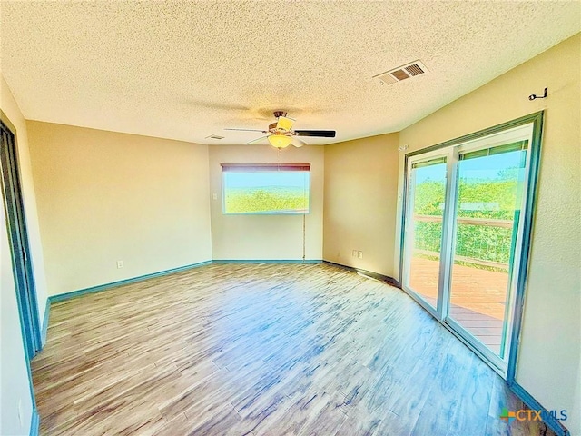 1795 Falconwood Dr, San Marcos, TX 78666 - spare room with wood finished floors, a textured ceiling, and ceiling fan