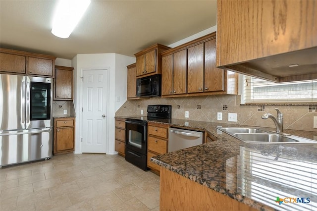 2102 Golden Eagle Dr, Killeen, TX 76549 - kitchen with black appliances, tasteful backsplash, and brown cabinetry