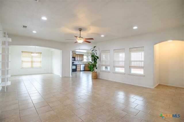 2102 Golden Eagle Dr, Killeen, TX 76549 - unfurnished living room featuring arched walkways, ceiling fan, and recessed lighting