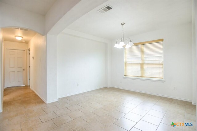 2102 Golden Eagle Dr, Killeen, TX 76549 - unfurnished room with arched walkways and a chandelier
