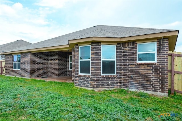 2102 Golden Eagle Dr, Killeen, TX 76549 - rear view of property featuring a lawn, brick siding, a patio area, and a shingled roof