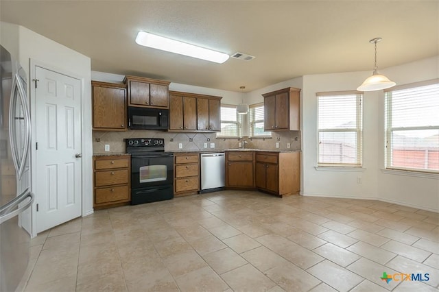 2102 Golden Eagle Dr, Killeen, TX 76549 - kitchen featuring black appliances, light tile patterned floors, decorative backsplash, pendant lighting, and brown cabinets
