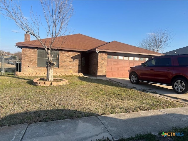 single story home featuring brick siding, a front lawn, concrete driveway, a chimney, and a garage