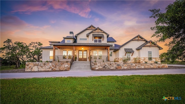 craftsman-style house featuring a yard and covered porch