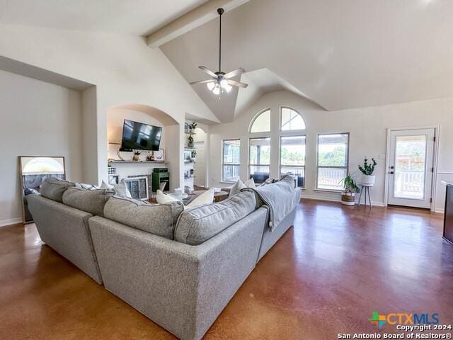 living area with baseboards, beam ceiling, a fireplace, high vaulted ceiling, and a ceiling fan