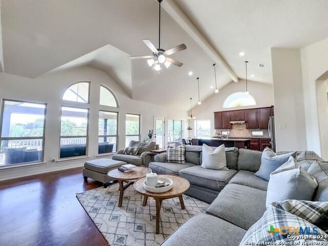 living area with wood finished floors, high vaulted ceiling, beam ceiling, recessed lighting, and ceiling fan