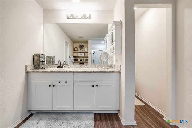 bathroom featuring vanity and wood-type flooring