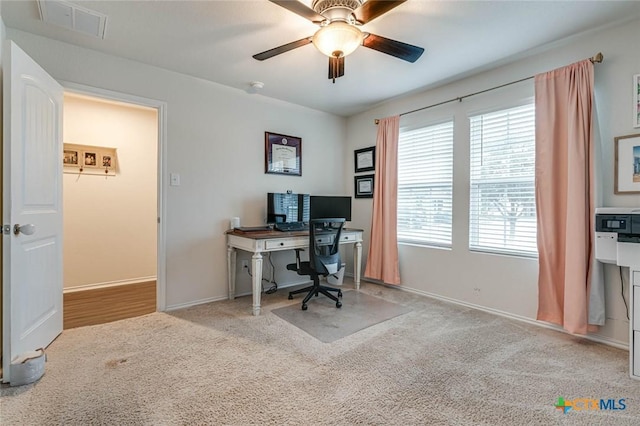 office space with light carpet and ceiling fan