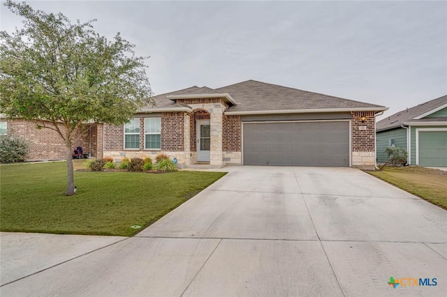 view of front of house with a garage and a front yard