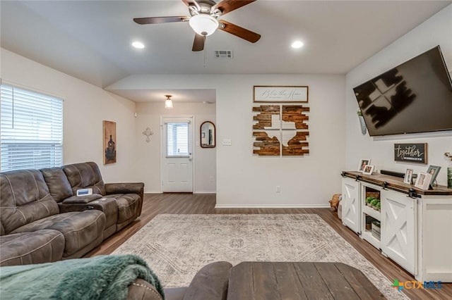 living room featuring ceiling fan, lofted ceiling, and hardwood / wood-style floors