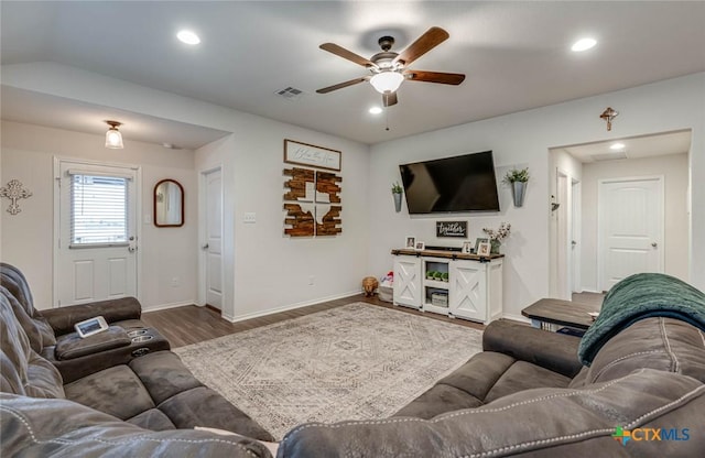 living room featuring wood-type flooring and ceiling fan