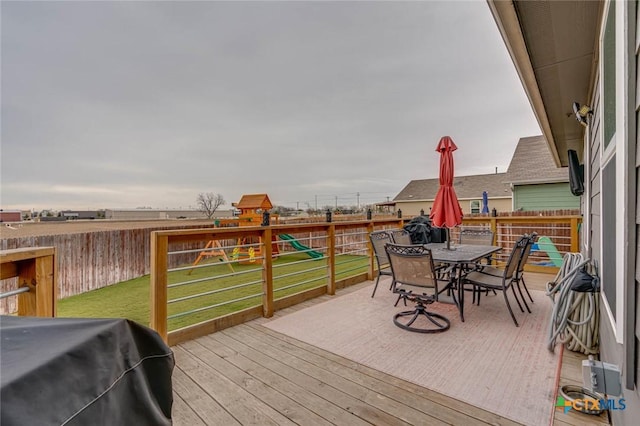 deck with a grill and a lawn