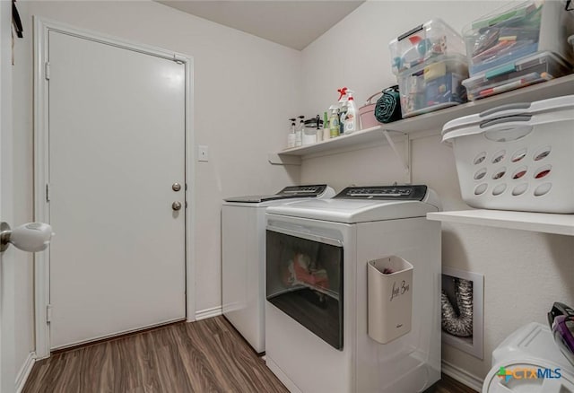 laundry area featuring dark wood-type flooring and washer and clothes dryer