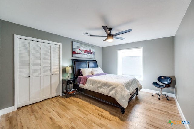 bedroom featuring a closet, baseboards, ceiling fan, and light wood finished floors