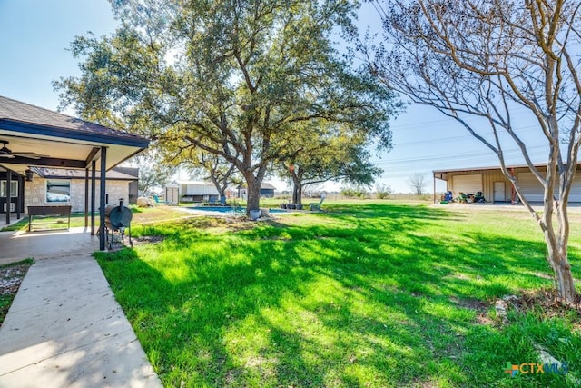 view of yard featuring a ceiling fan