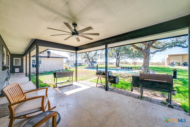 sunroom / solarium featuring ceiling fan