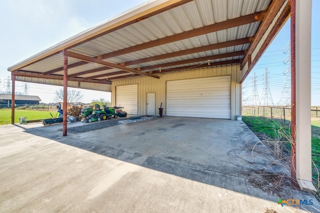 garage with a detached garage and fence