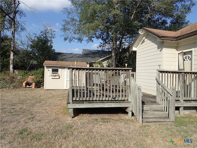 wooden terrace featuring a yard and a storage unit