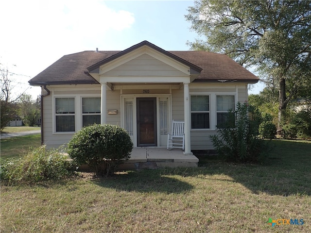 bungalow with a porch and a front lawn