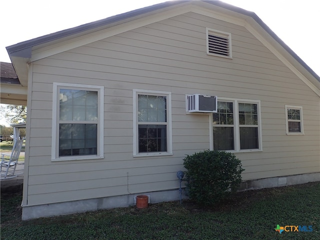 view of home's exterior with an AC wall unit