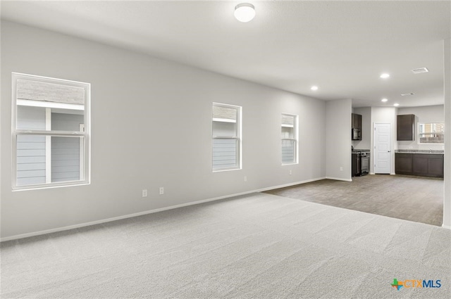 unfurnished living room with light carpet