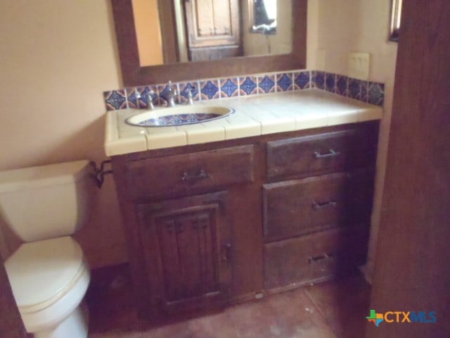 bathroom featuring vanity and toilet