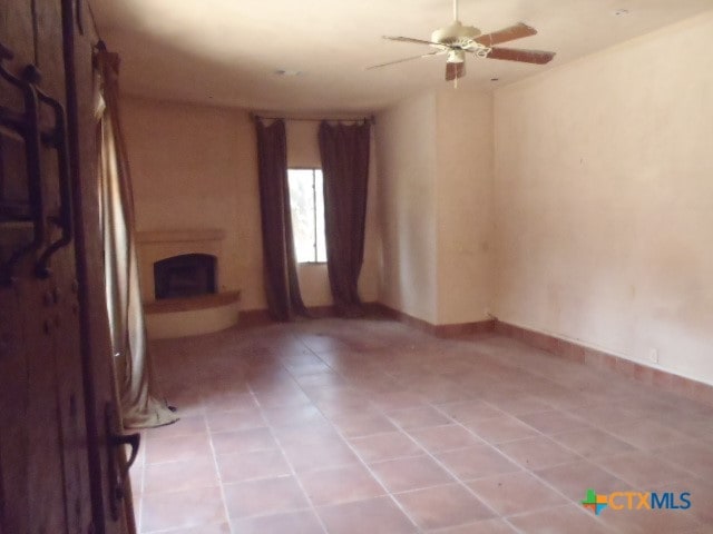 unfurnished living room featuring ceiling fan