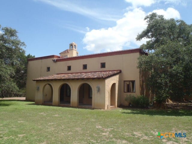 back of property featuring a lawn