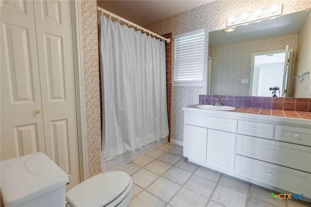 bathroom featuring toilet, tile patterned floors, wallpapered walls, and vanity