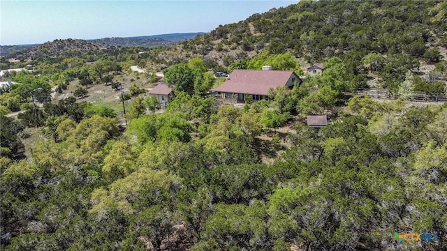 birds eye view of property with a view of trees
