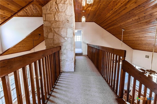 corridor featuring carpet flooring, visible vents, wooden ceiling, and lofted ceiling