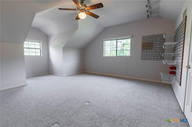 bonus room with baseboards, plenty of natural light, carpet, and lofted ceiling