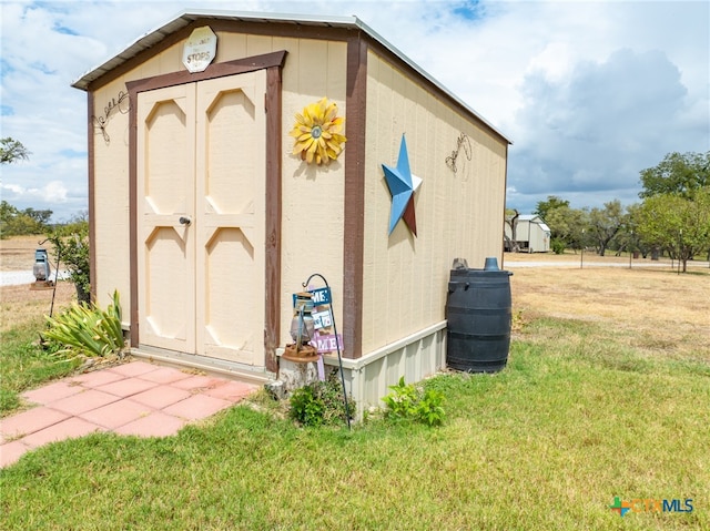 view of outbuilding featuring a yard