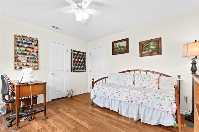 bedroom featuring hardwood / wood-style floors and ceiling fan